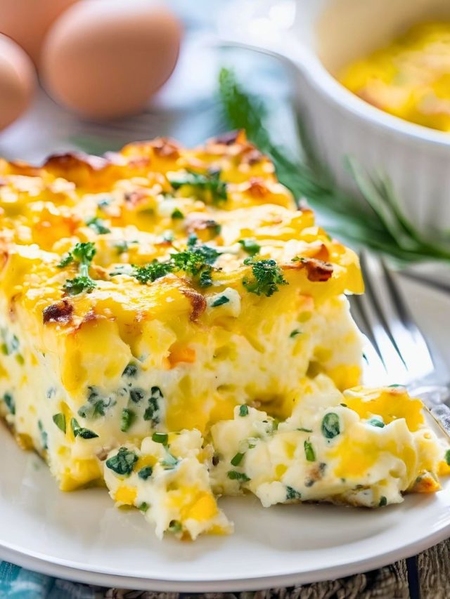 Golden-brown breakfast casserole featuring fluffy eggs, creamy cottage cheese, and fresh herbs baked in a rectangular dish.